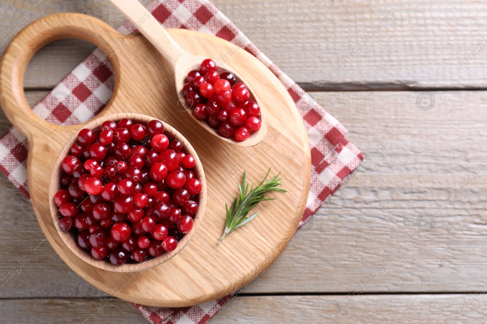 Photo of Fresh ripe cranberries on wooden table, top view