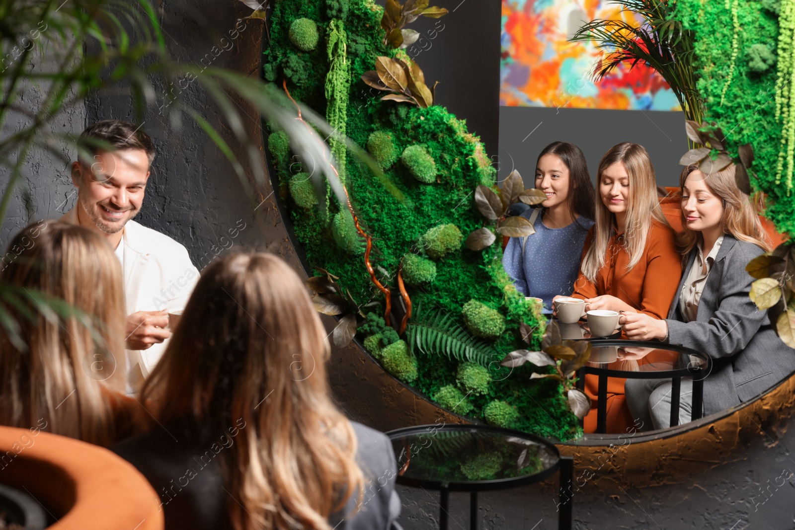 Photo of People with coffee spending time together in cafe