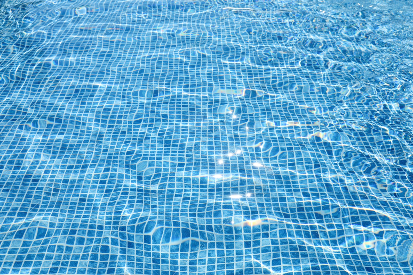 Photo of Swimming pool with clean blue water as background. Summer vacation