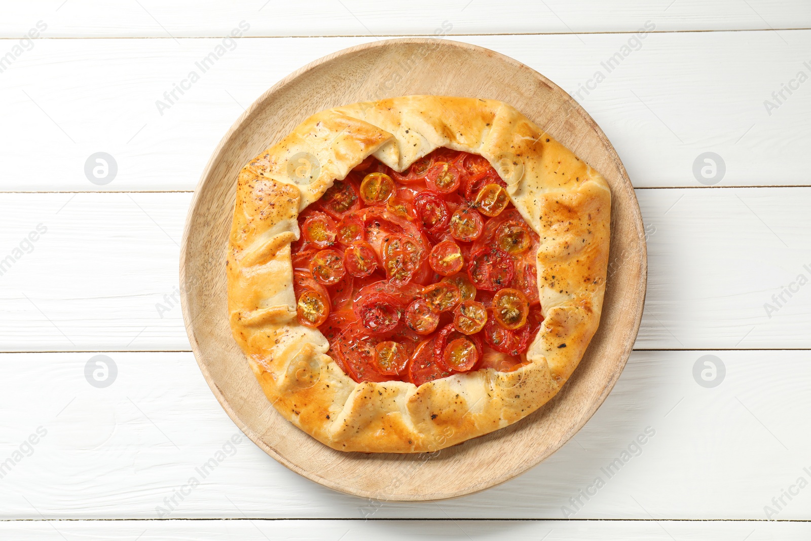 Photo of Tasty tomato galette (Caprese galette) on white wooden table, top view