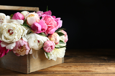 Photo of Bouquet of beautiful peonies on wooden table. Space for text