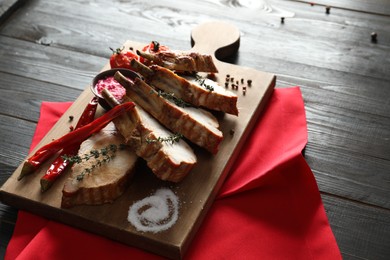 Delicious roasted ribs served on wooden table