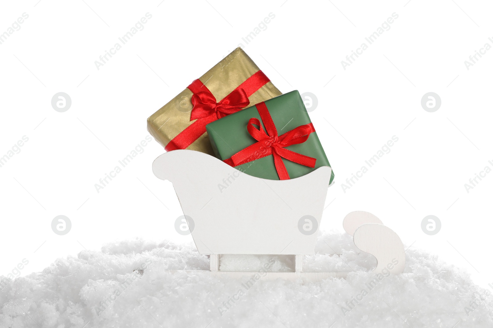 Photo of Wooden sleigh with Christmas gift boxes and artificial snow on white background