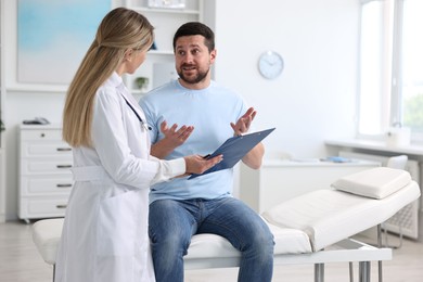 Photo of Professional doctor working with patient in hospital, space for text