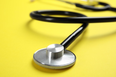 Photo of Stethoscope on color background, closeup. Medical tool