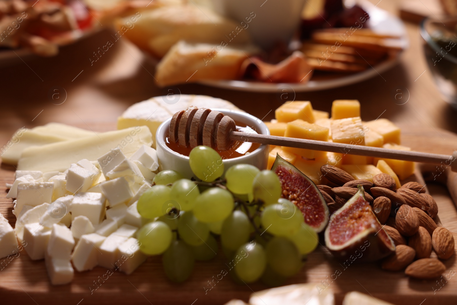 Photo of Assorted appetizers served on wooden table, closeup