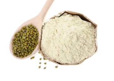 Photo of Mung bean flour in paper bag and wooden spoon with seeds isolated on white, top view