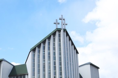 Photo of Exterior of modern church against blue sky with clouds