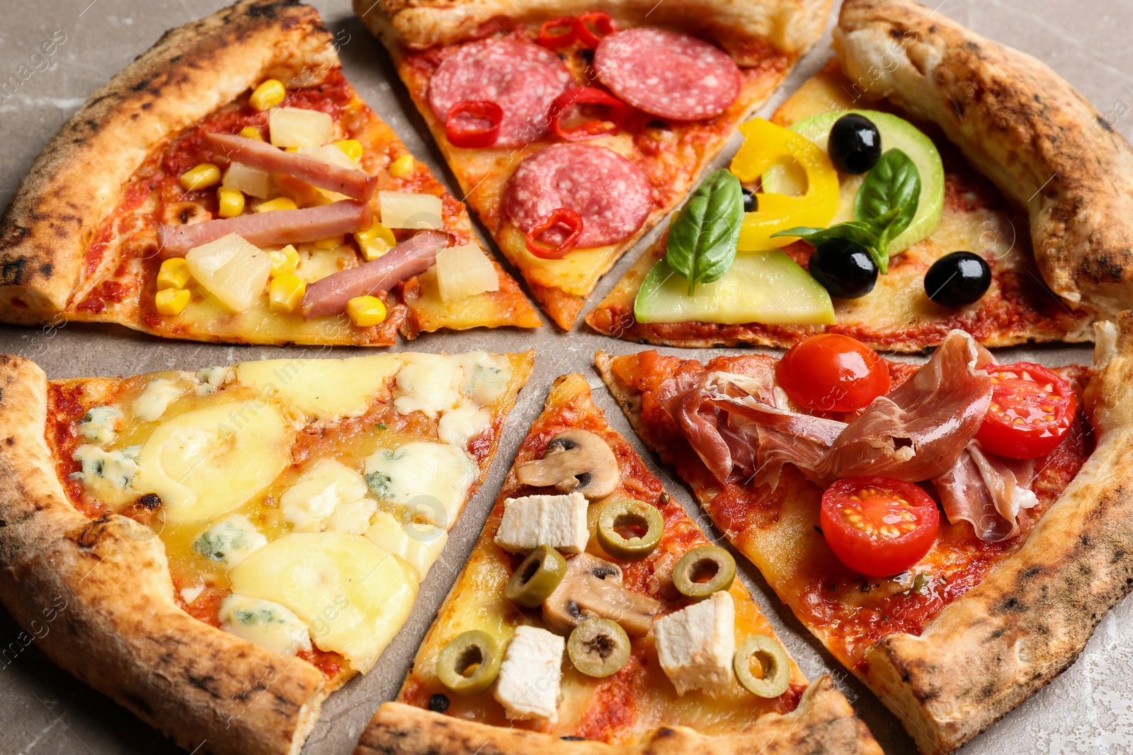 Photo of Slices of different delicious pizzas on table, closeup