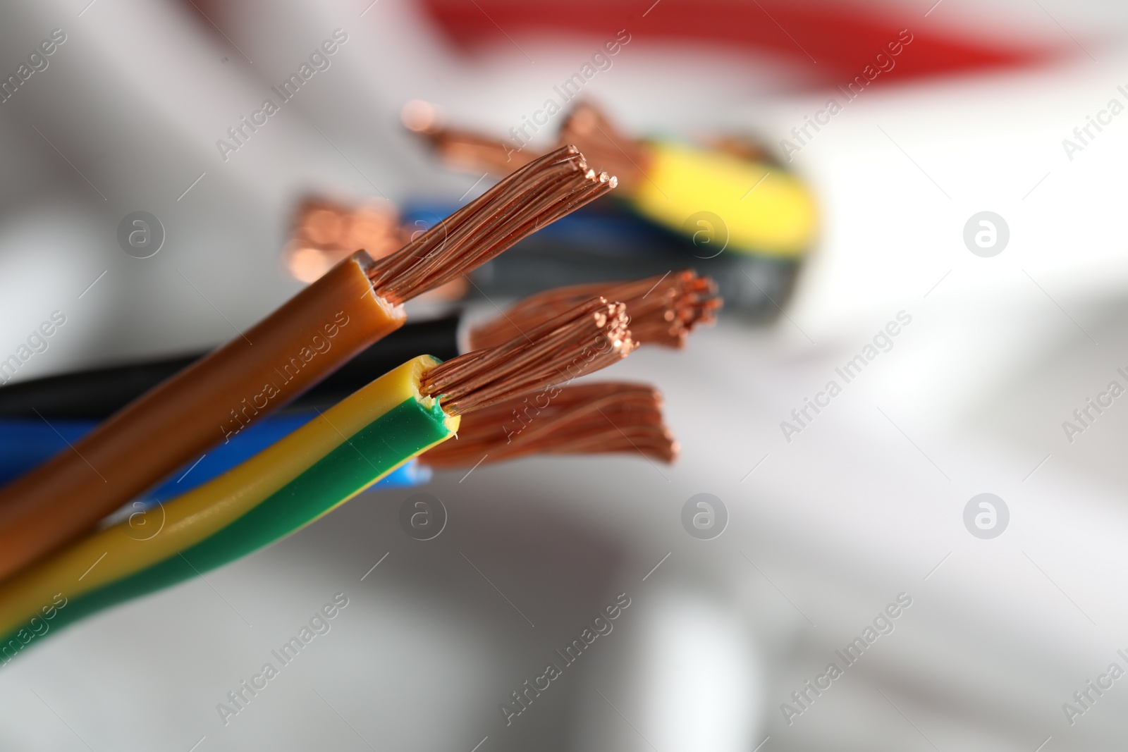 Photo of Colorful electrical wires on blurred background, closeup