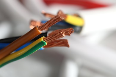 Photo of Colorful electrical wires on blurred background, closeup