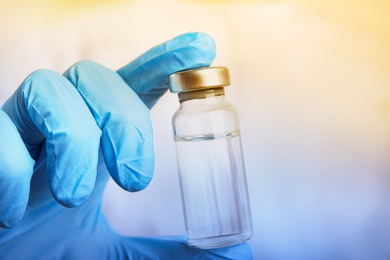 Image of Doctor holding vial with medication, closeup. Vaccination and immunization