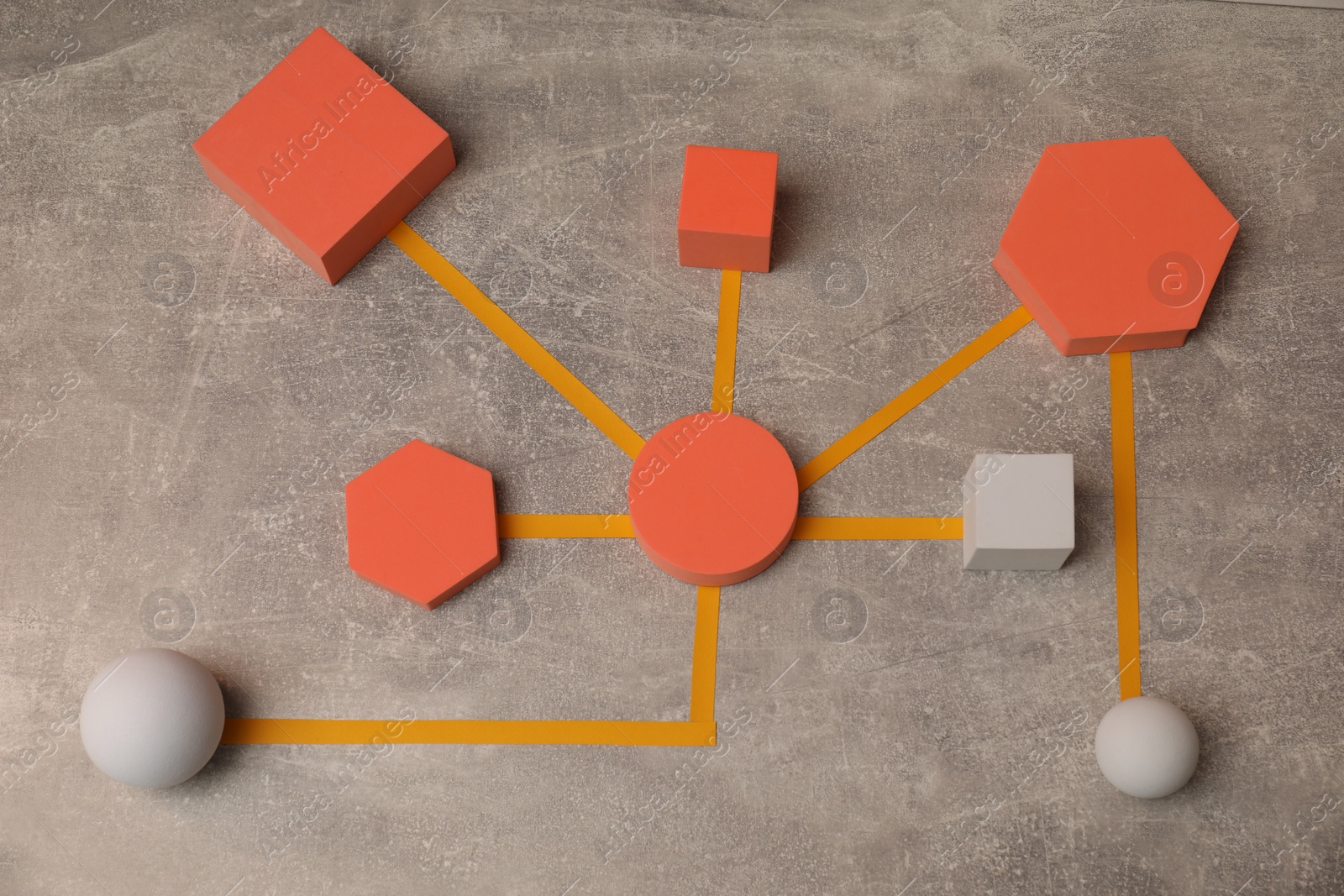 Photo of Business process organization and optimization. Scheme with geometric figures on grey table, above view