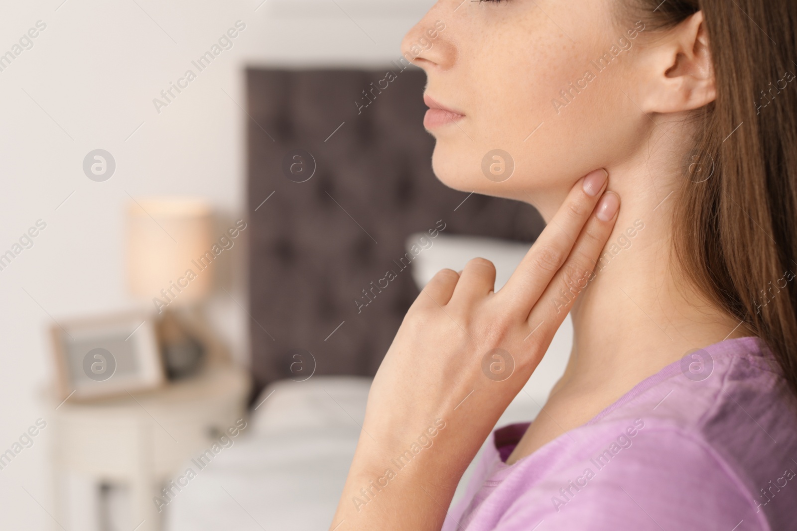 Photo of Young woman checking pulse indoors, closeup. Space for text