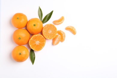 Photo of Composition with tangerines and leaves on white background, top view. Space for text