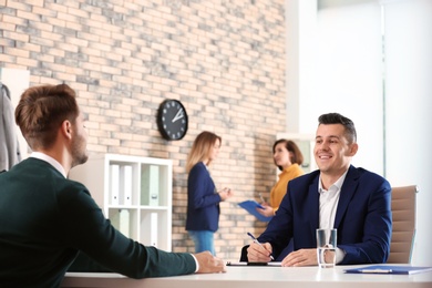 Photo of Human resources manager conducting job interview with applicant in office