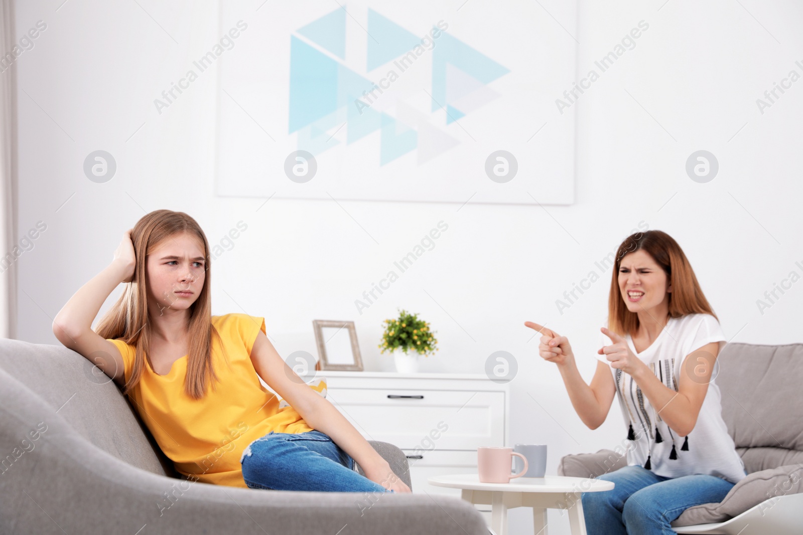 Photo of Mother scolding her teenager daughter at home