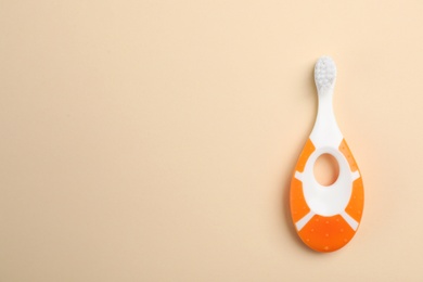 Manual toothbrush for child on color background, top view with space for text