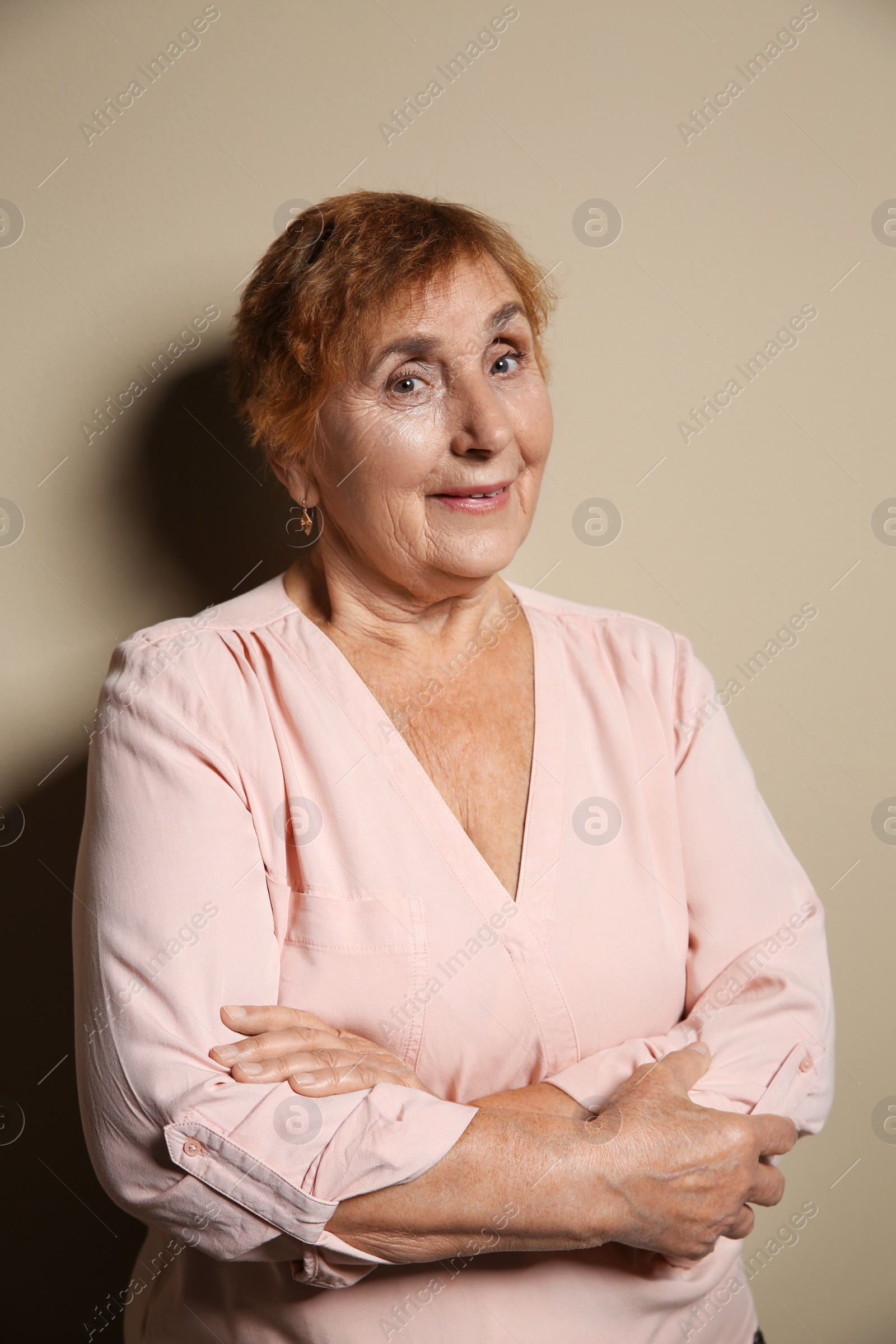 Photo of Portrait of elderly woman on color background