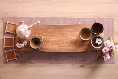 Photo of Beautiful set for traditional tea ceremony on wooden table, flat lay