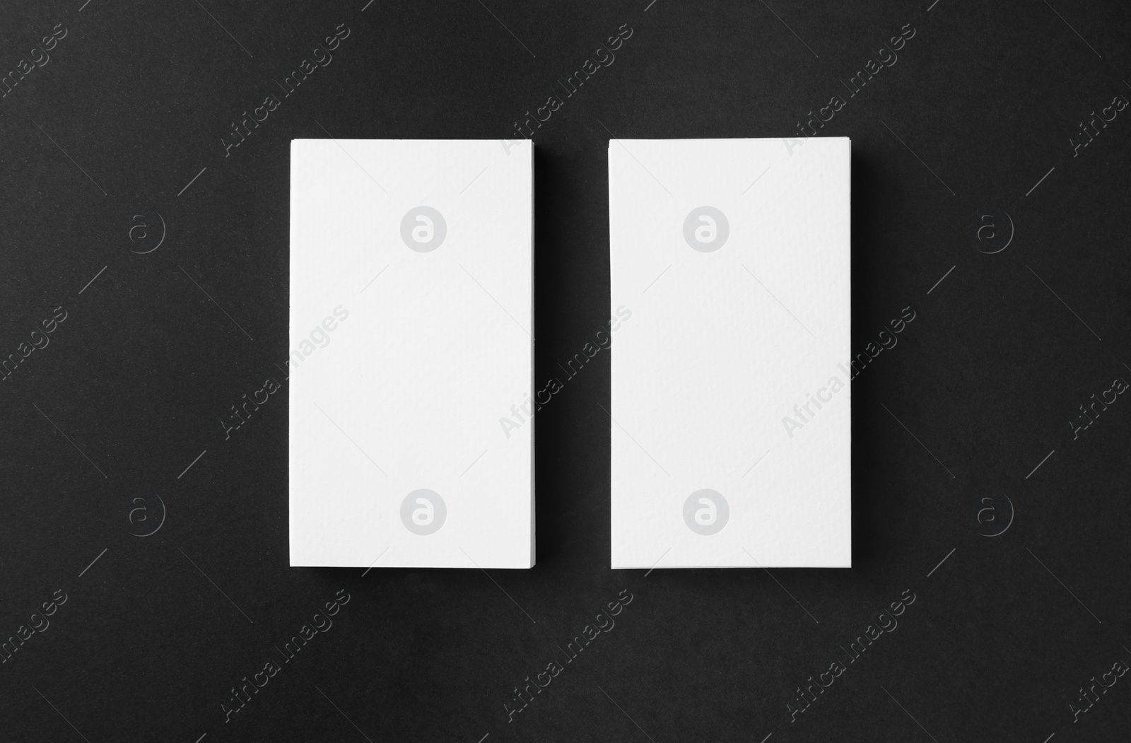 Photo of Blank business cards on black background, flat lay. Mockup for design