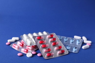 Photo of Blisters of different antidepressants with emoticons on blue background