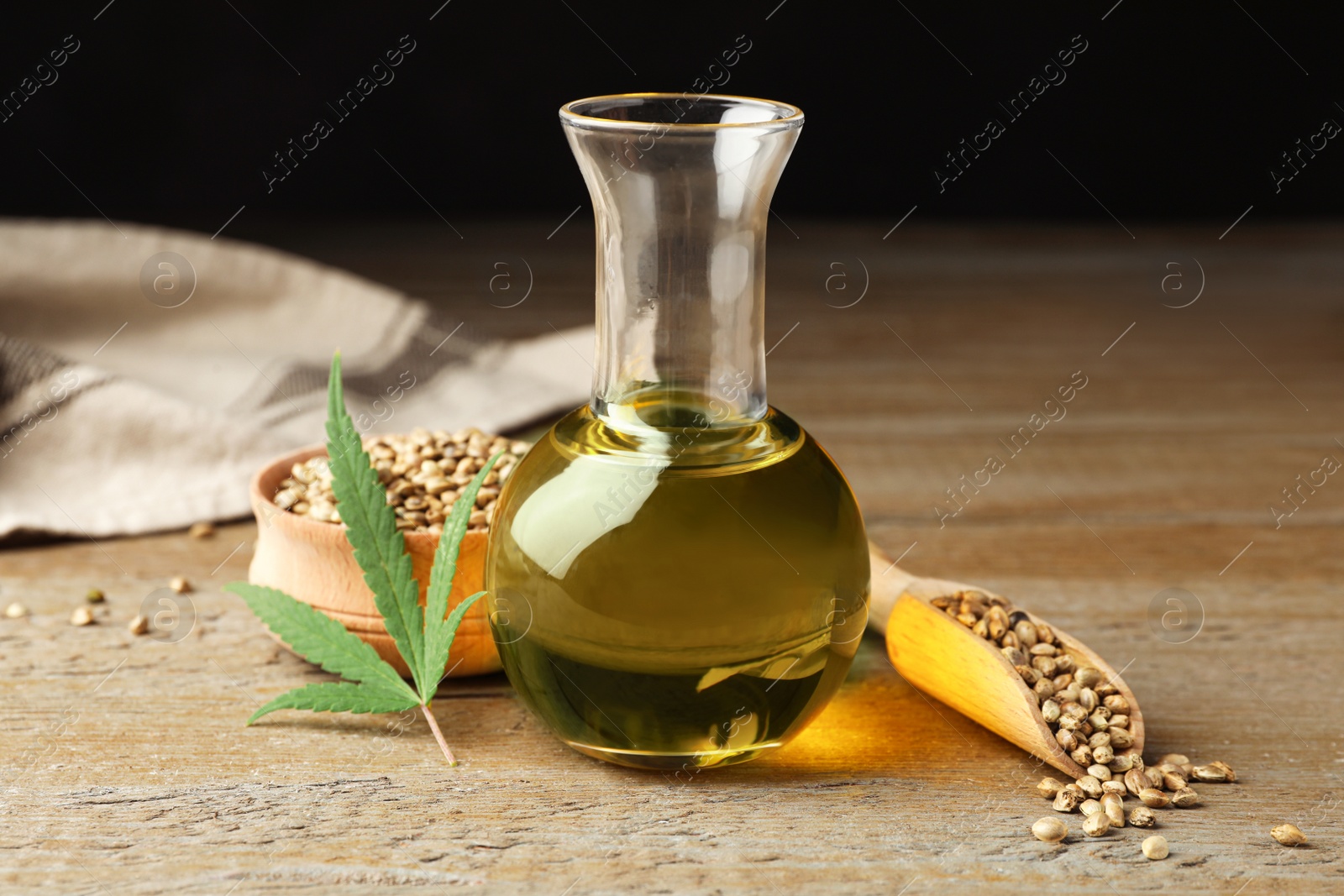 Photo of Composition with hemp oil on wooden table