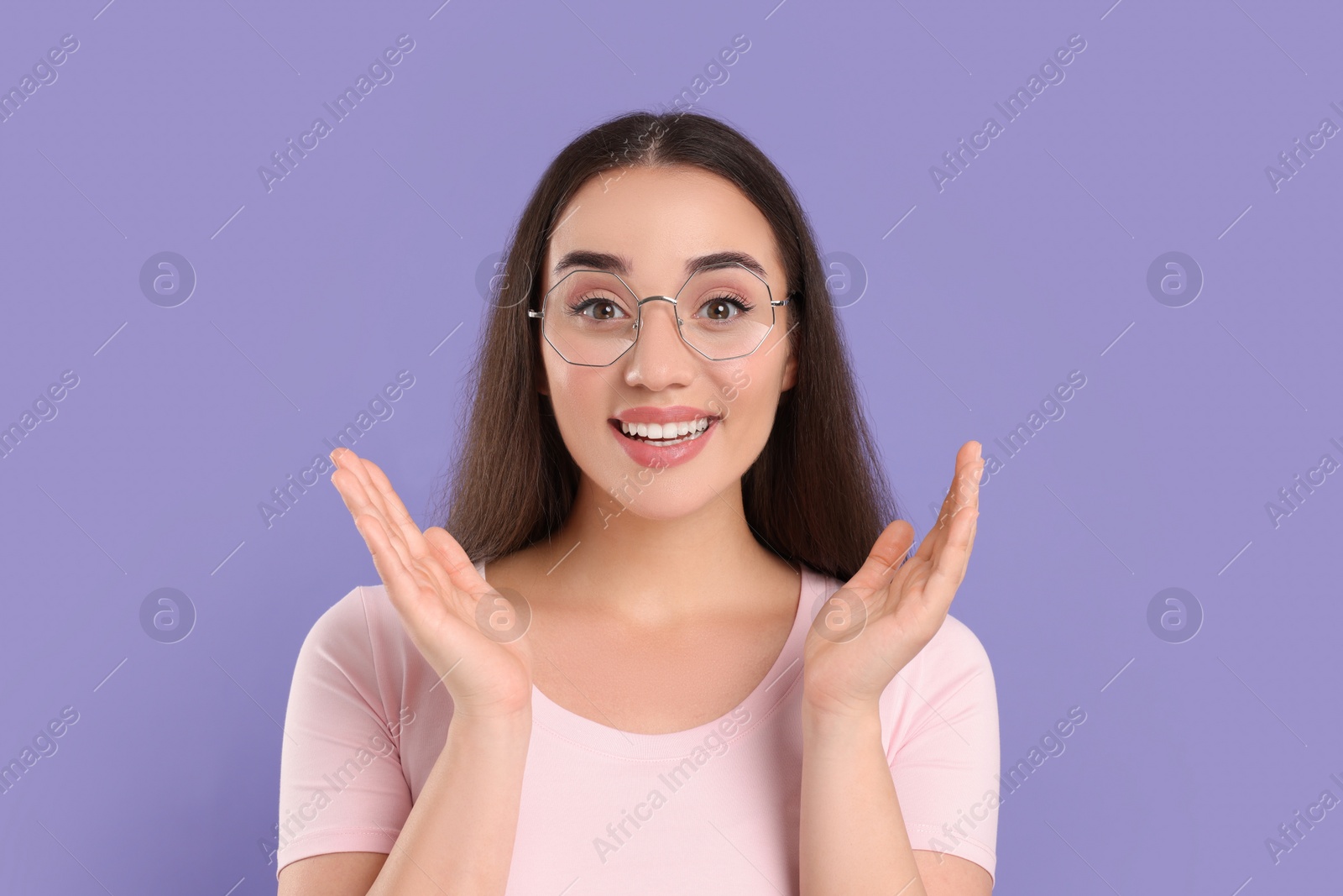 Photo of Beautiful woman wearing glasses on violet background