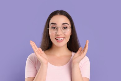 Photo of Beautiful woman wearing glasses on violet background