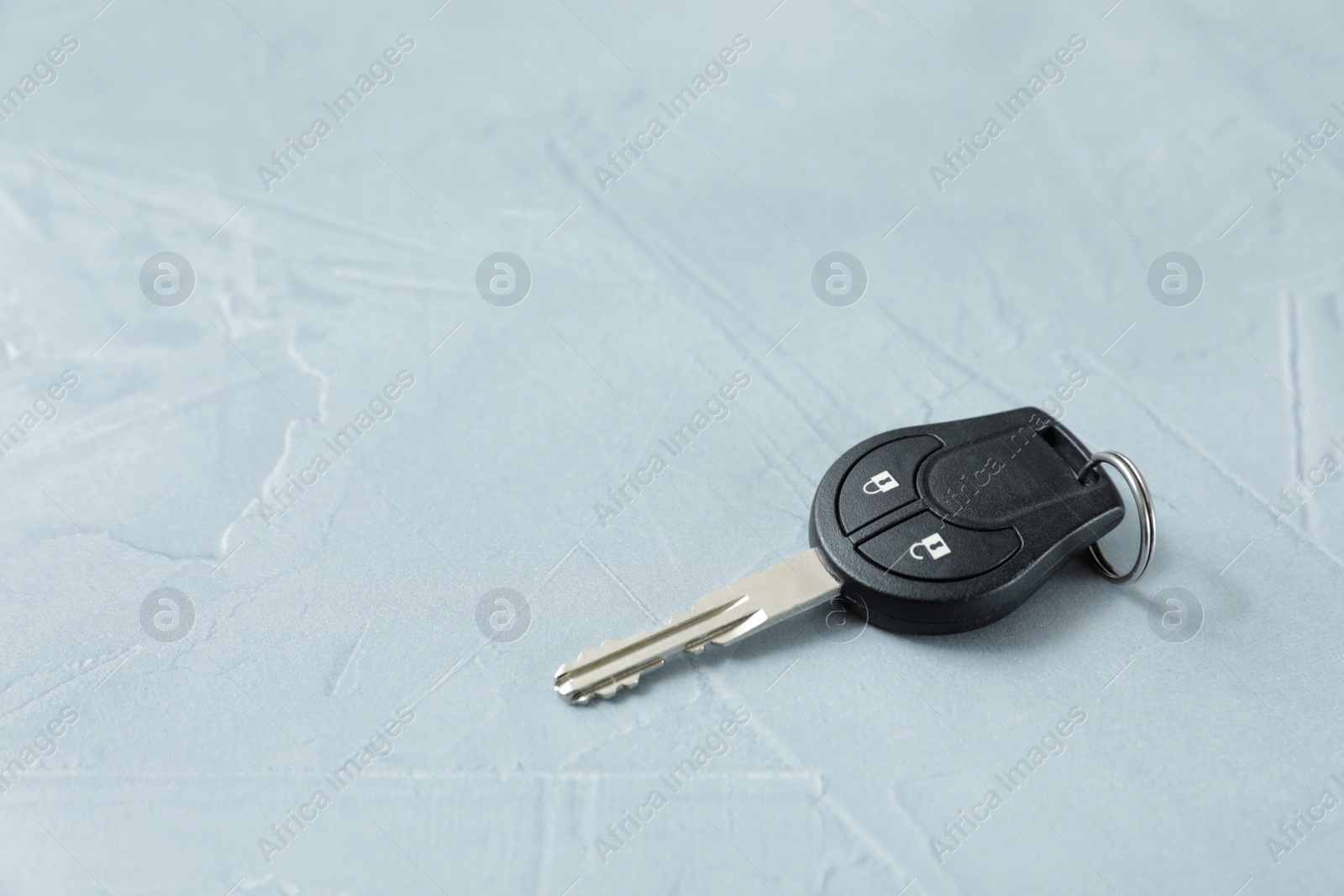 Photo of Car key on grey background. Space for text