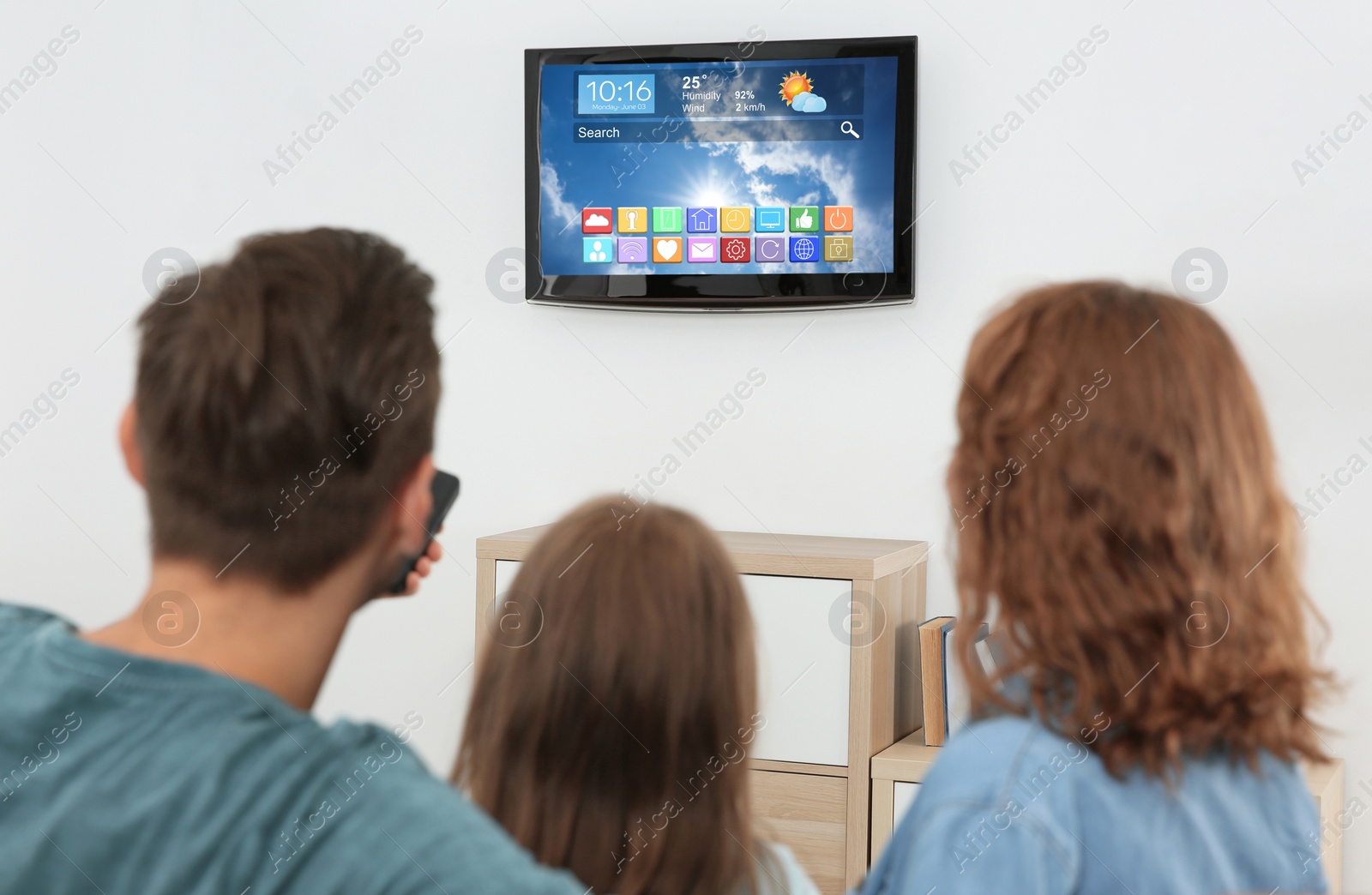 Image of Family watching smart TV in living room