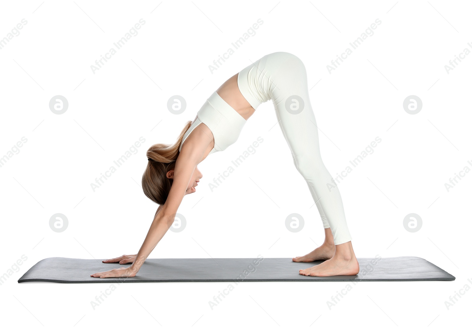 Photo of Young woman in sportswear practicing yoga on white background