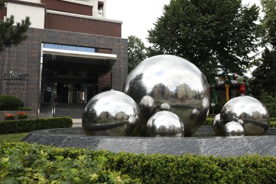 Photo of Truskavets, Ukraine - July 22, 2023: Beautiful fountain near hotel on city street