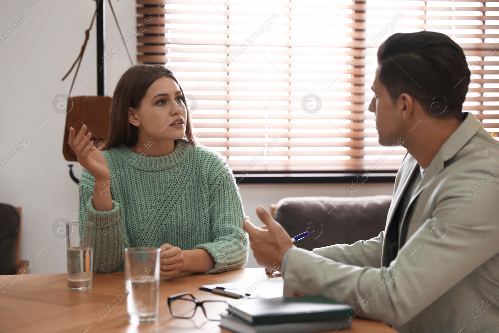 Photo of Professional psychotherapist working with patient in office