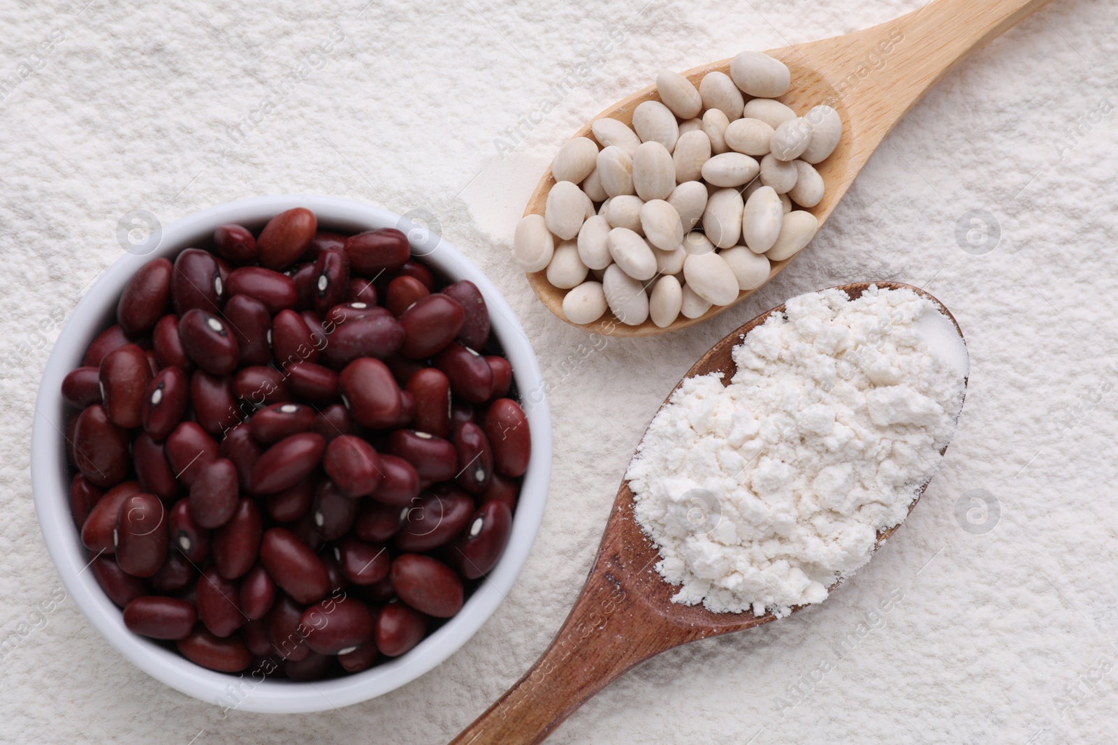 Photo of Different seeds on kidney bean flour, flat lay