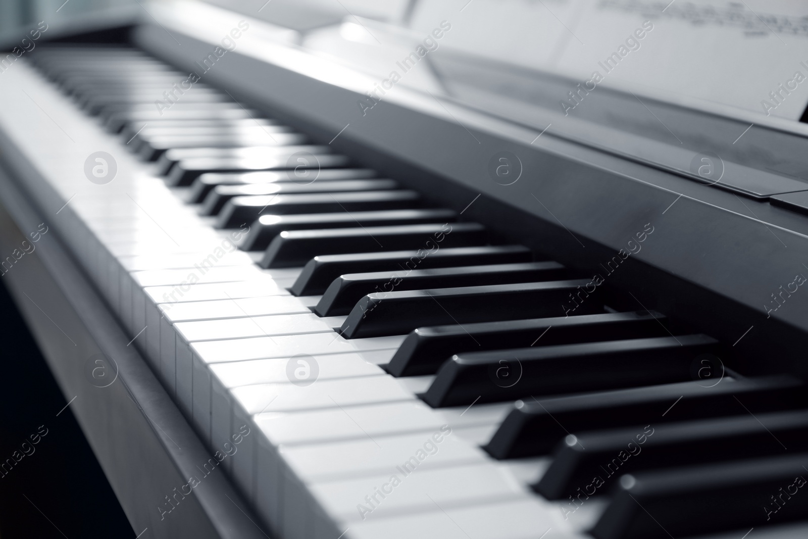 Photo of Modern piano with black and white keys, closeup