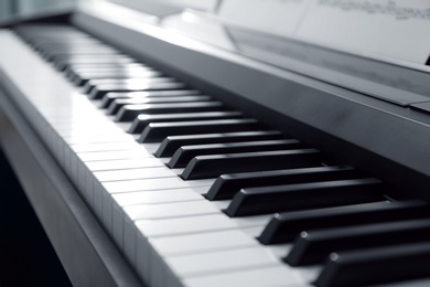 Photo of Modern piano with black and white keys, closeup