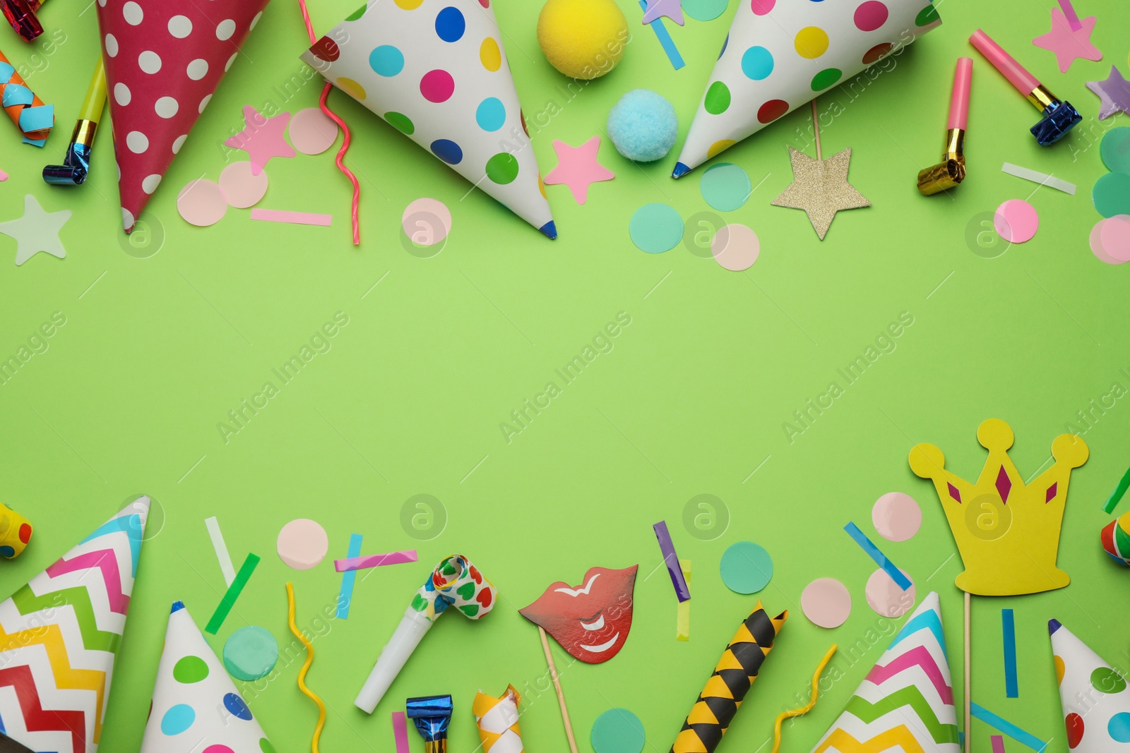 Photo of Flat lay composition with party hats and other festive items on light green background. Space for text