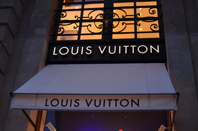 Photo of Paris, France - December 10, 2022: Louis Vuitton store exterior in evening