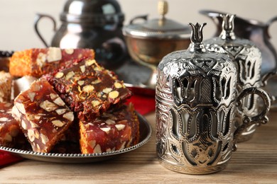 Tea and Turkish delight served in vintage tea set on wooden table, closeup