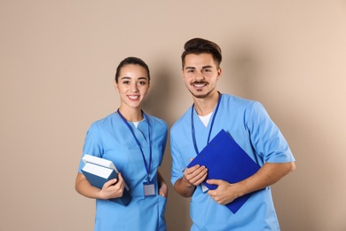 Photo of Happy young medical students on color background