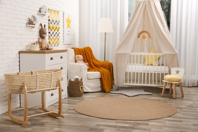 Photo of Stylish baby's room with comfortable cot. Interior design
