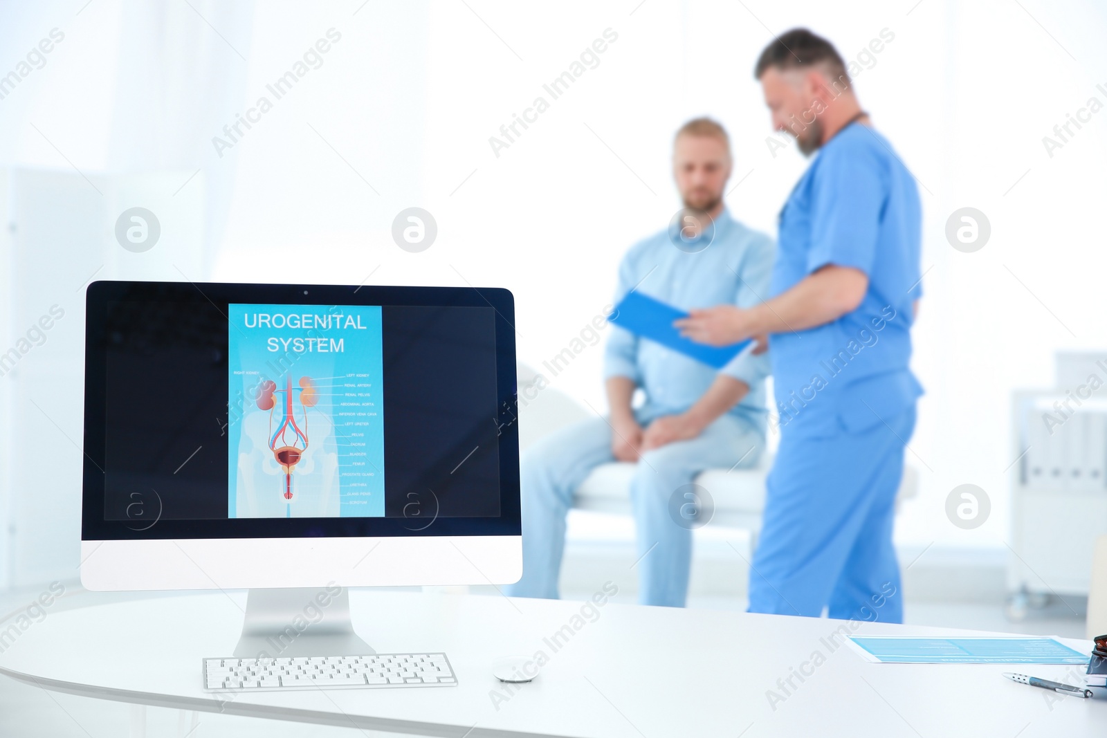 Photo of Computer monitor with picture of urogenital system and people on background