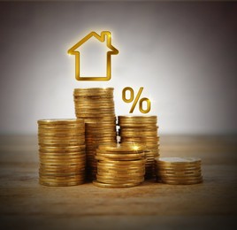 Image of Mortgage concept. Many stacks of coins and house model on table against light background