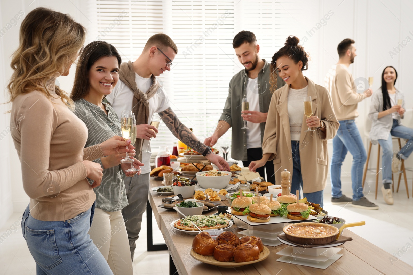 Photo of Group of people enjoying brunch buffet together indoors