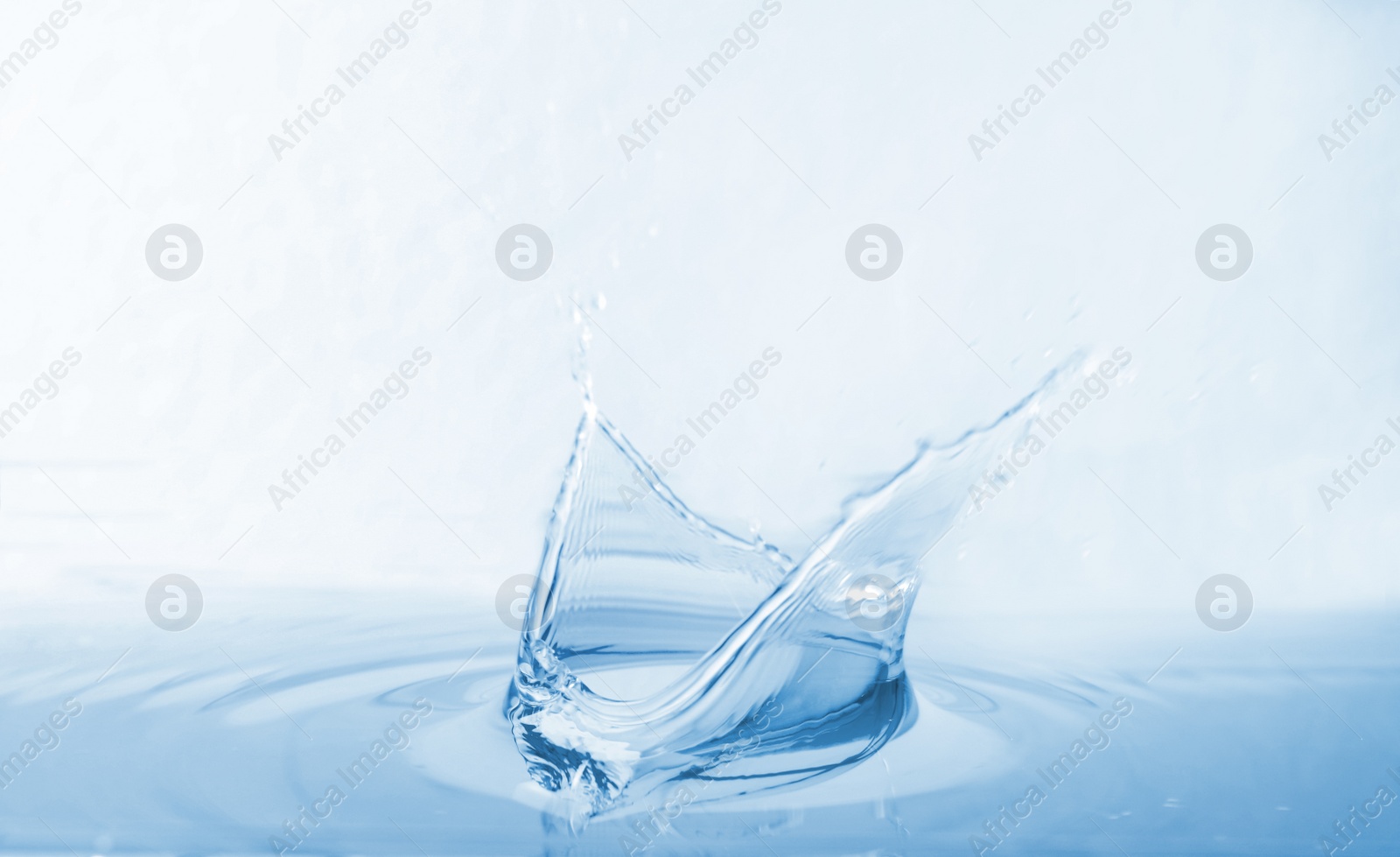 Photo of Splash of water with drops on white background, closeup