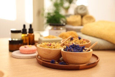 Dry flowers on wooden table indoors. Spa time