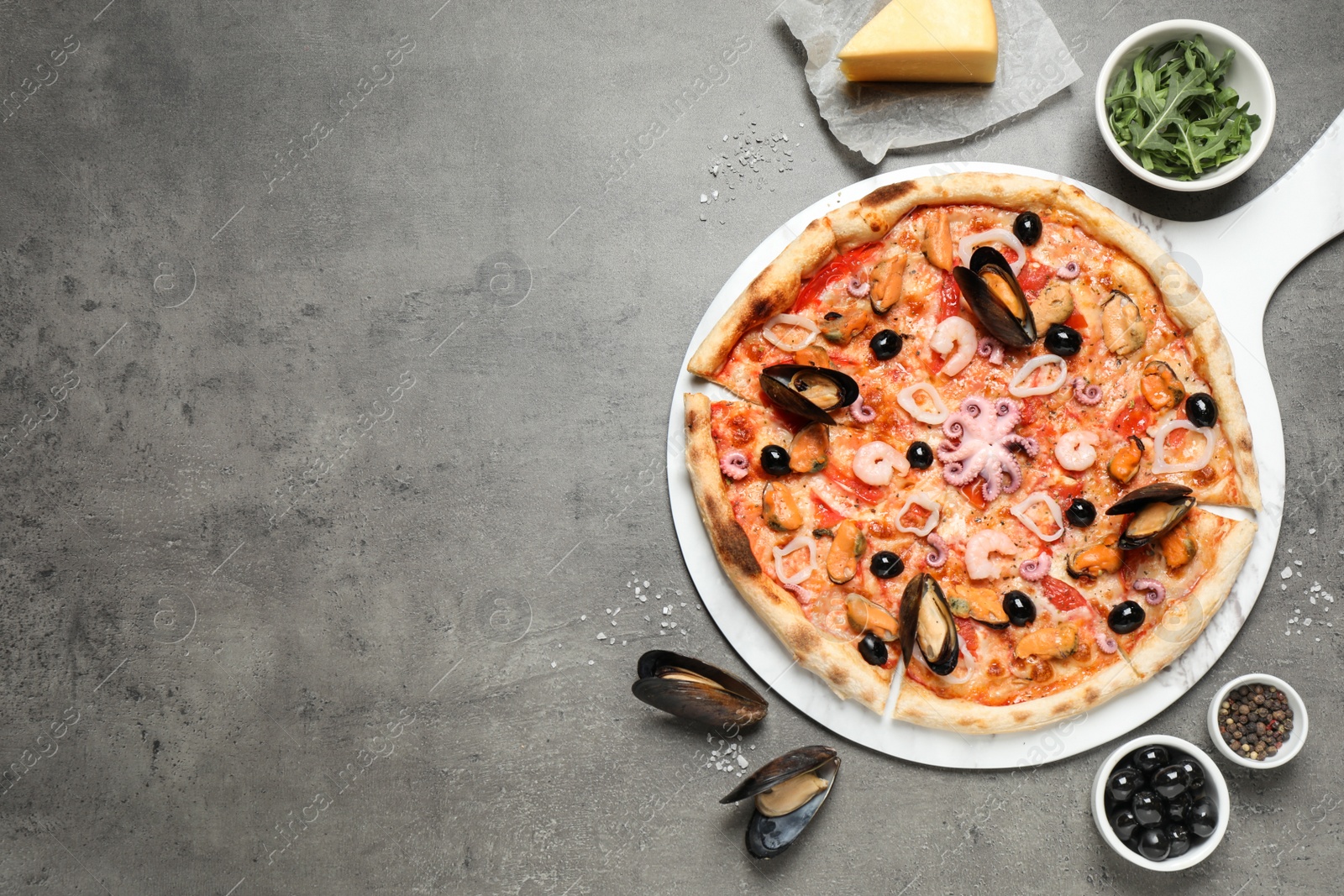 Photo of Delicious seafood pizza on grey table, flat lay. Space for text