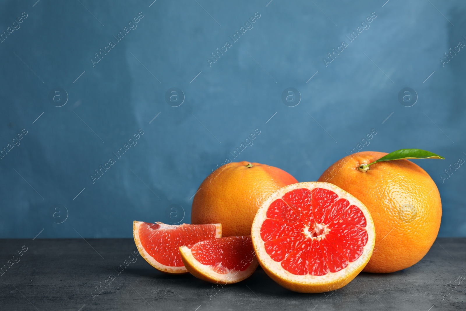 Photo of Fresh tasty grapefruits on table. Space for text