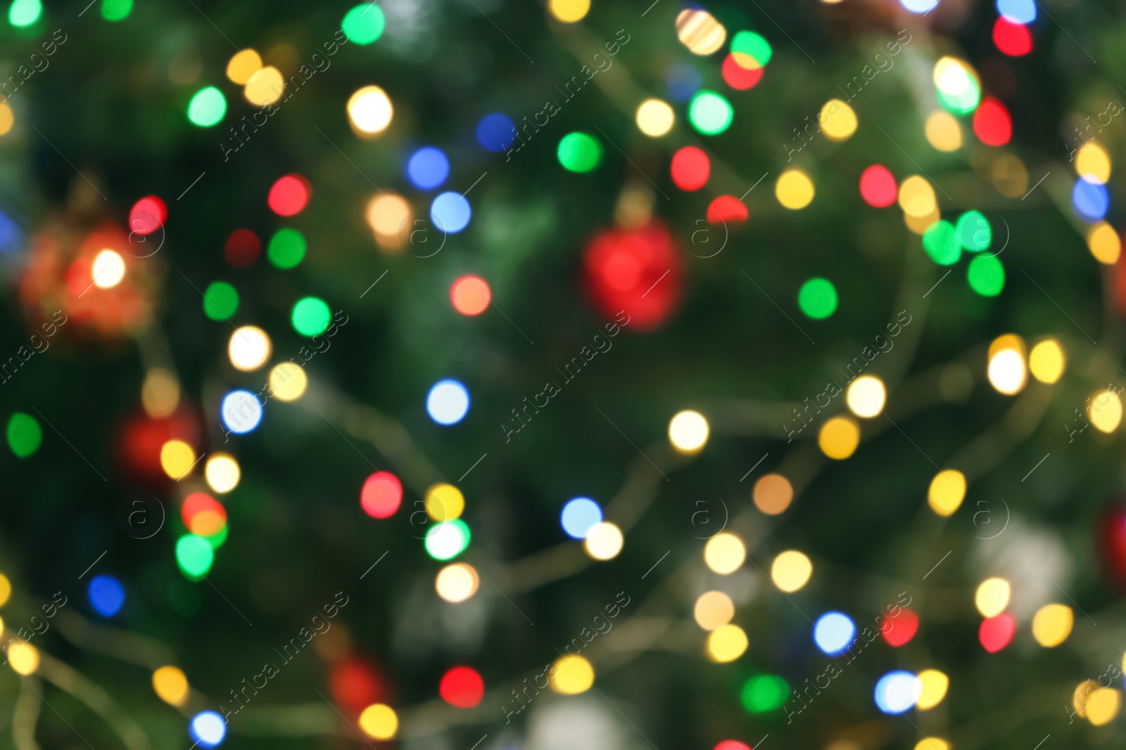 Photo of Blurred view of glowing Christmas lights as background. Festive mood